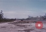 Image of UH-1Ds' and UH-1Bs' helicopters landing US troops during Operation Att Dau Tieng Vietnam, 1966, second 60 stock footage video 65675026866