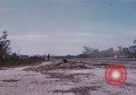 Image of UH-1Ds' and UH-1Bs' helicopters landing US troops during Operation Att Dau Tieng Vietnam, 1966, second 61 stock footage video 65675026866