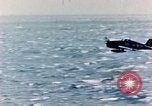 Image of a fighter jet rapidly sinking in water United States USA, 1965, second 29 stock footage video 65675027018