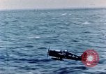Image of a fighter jet rapidly sinking in water United States USA, 1965, second 32 stock footage video 65675027018