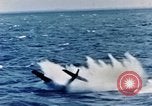 Image of a fighter jet rapidly sinking in water United States USA, 1965, second 34 stock footage video 65675027018