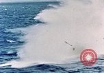 Image of a fighter jet rapidly sinking in water United States USA, 1965, second 36 stock footage video 65675027018