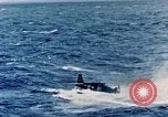 Image of a fighter jet rapidly sinking in water United States USA, 1965, second 39 stock footage video 65675027018