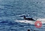 Image of a fighter jet rapidly sinking in water United States USA, 1965, second 42 stock footage video 65675027018