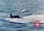 Image of a fighter jet rapidly sinking in water United States USA, 1965, second 44 stock footage video 65675027018