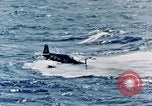 Image of a fighter jet rapidly sinking in water United States USA, 1965, second 45 stock footage video 65675027018