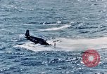 Image of a fighter jet rapidly sinking in water United States USA, 1965, second 46 stock footage video 65675027018