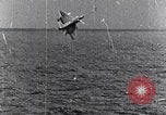 Image of a fighter jet rapidly sinking in water United States USA, 1965, second 49 stock footage video 65675027018