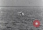 Image of a fighter jet rapidly sinking in water United States USA, 1965, second 54 stock footage video 65675027018