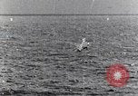 Image of a fighter jet rapidly sinking in water United States USA, 1965, second 55 stock footage video 65675027018