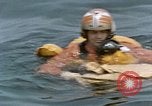 Image of jet pilot water rescue United States USA, 1965, second 50 stock footage video 65675027024