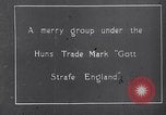 Image of British troops smiling beneath German sign in World War 1 France, 1917, second 4 stock footage video 65675027260