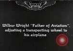 Image of Wilbur Wright adjusting transporter wheel on flyer United States USA, 1908, second 1 stock footage video 65675027433
