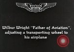 Image of Wilbur Wright adjusting transporter wheel on flyer United States USA, 1908, second 3 stock footage video 65675027433