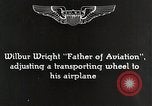 Image of Wilbur Wright adjusting transporter wheel on flyer United States USA, 1908, second 4 stock footage video 65675027433