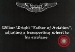 Image of Wilbur Wright adjusting transporter wheel on flyer United States USA, 1908, second 5 stock footage video 65675027433