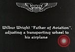 Image of Wilbur Wright adjusting transporter wheel on flyer United States USA, 1908, second 7 stock footage video 65675027433