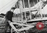 Image of Wilbur Wright adjusting transporter wheel on flyer United States USA, 1908, second 11 stock footage video 65675027433