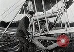 Image of Wilbur Wright adjusting transporter wheel on flyer United States USA, 1908, second 12 stock footage video 65675027433