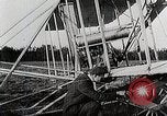 Image of Wilbur Wright adjusting transporter wheel on flyer United States USA, 1908, second 13 stock footage video 65675027433