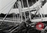Image of Wilbur Wright adjusting transporter wheel on flyer United States USA, 1908, second 14 stock footage video 65675027433