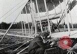Image of Wilbur Wright adjusting transporter wheel on flyer United States USA, 1908, second 15 stock footage video 65675027433
