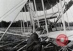 Image of Wilbur Wright adjusting transporter wheel on flyer United States USA, 1908, second 16 stock footage video 65675027433