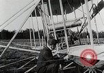 Image of Wilbur Wright adjusting transporter wheel on flyer United States USA, 1908, second 17 stock footage video 65675027433
