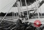 Image of Wilbur Wright adjusting transporter wheel on flyer United States USA, 1908, second 18 stock footage video 65675027433