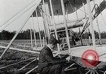 Image of Wilbur Wright adjusting transporter wheel on flyer United States USA, 1908, second 19 stock footage video 65675027433