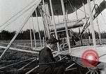 Image of Wilbur Wright adjusting transporter wheel on flyer United States USA, 1908, second 20 stock footage video 65675027433