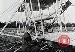 Image of Wilbur Wright adjusting transporter wheel on flyer United States USA, 1908, second 22 stock footage video 65675027433