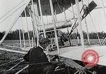 Image of Wilbur Wright adjusting transporter wheel on flyer United States USA, 1908, second 23 stock footage video 65675027433