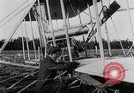 Image of Wilbur Wright adjusting transporter wheel on flyer United States USA, 1908, second 24 stock footage video 65675027433