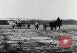 Image of Wilbur Wright adjusting transporter wheel on flyer United States USA, 1908, second 25 stock footage video 65675027433