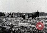 Image of Wilbur Wright adjusting transporter wheel on flyer United States USA, 1908, second 26 stock footage video 65675027433