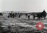 Image of Wilbur Wright adjusting transporter wheel on flyer United States USA, 1908, second 29 stock footage video 65675027433