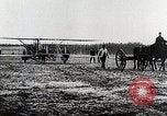 Image of Wilbur Wright adjusting transporter wheel on flyer United States USA, 1908, second 30 stock footage video 65675027433