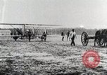 Image of Wilbur Wright adjusting transporter wheel on flyer United States USA, 1908, second 32 stock footage video 65675027433