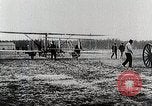 Image of Wilbur Wright adjusting transporter wheel on flyer United States USA, 1908, second 34 stock footage video 65675027433