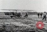 Image of Wilbur Wright adjusting transporter wheel on flyer United States USA, 1908, second 35 stock footage video 65675027433