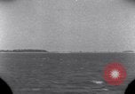 Standbild OS2U Kingfisher scout Wasserflugzeug landet in Wasser Majuro Marshall Inseln, 1944, aus Sekunde 7 historischem Filmmaterial Videoclip 65675028036