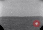 Standbild OS2U Kingfisher scout Wasserflugzeug landet in Wasser Majuro Marshall Inseln, 1944, aus Sekunde 13 historischem Filmmaterial Videoclip 65675028036