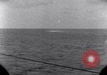 Standbild OS2U Kingfisher scout Wasserflugzeug landet in Wasser Majuro Marshall Inseln, 1944, aus Sekunde 58 historischem Filmmaterial Videoclip 65675028036