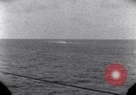 Standbild OS2U Kingfisher scout Wasserflugzeug landet in Wasser Majuro Marshall Inseln, 1944, aus Sekunde 62 historischem Filmmaterial Videoclip 65675028036