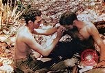 Image of Marine renders first aid to wounded buddy Saipan Northern Mariana Islands, 1944, second 4 stock footage video 65675028048