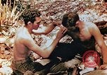 Image of Marine renders first aid to wounded buddy Saipan Northern Mariana Islands, 1944, second 5 stock footage video 65675028048