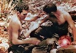 Image of Marine renders first aid to wounded buddy Saipan Northern Mariana Islands, 1944, second 6 stock footage video 65675028048