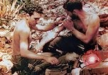 Image of Marine renders first aid to wounded buddy Saipan Northern Mariana Islands, 1944, second 7 stock footage video 65675028048