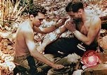 Image of Marine renders first aid to wounded buddy Saipan Northern Mariana Islands, 1944, second 8 stock footage video 65675028048